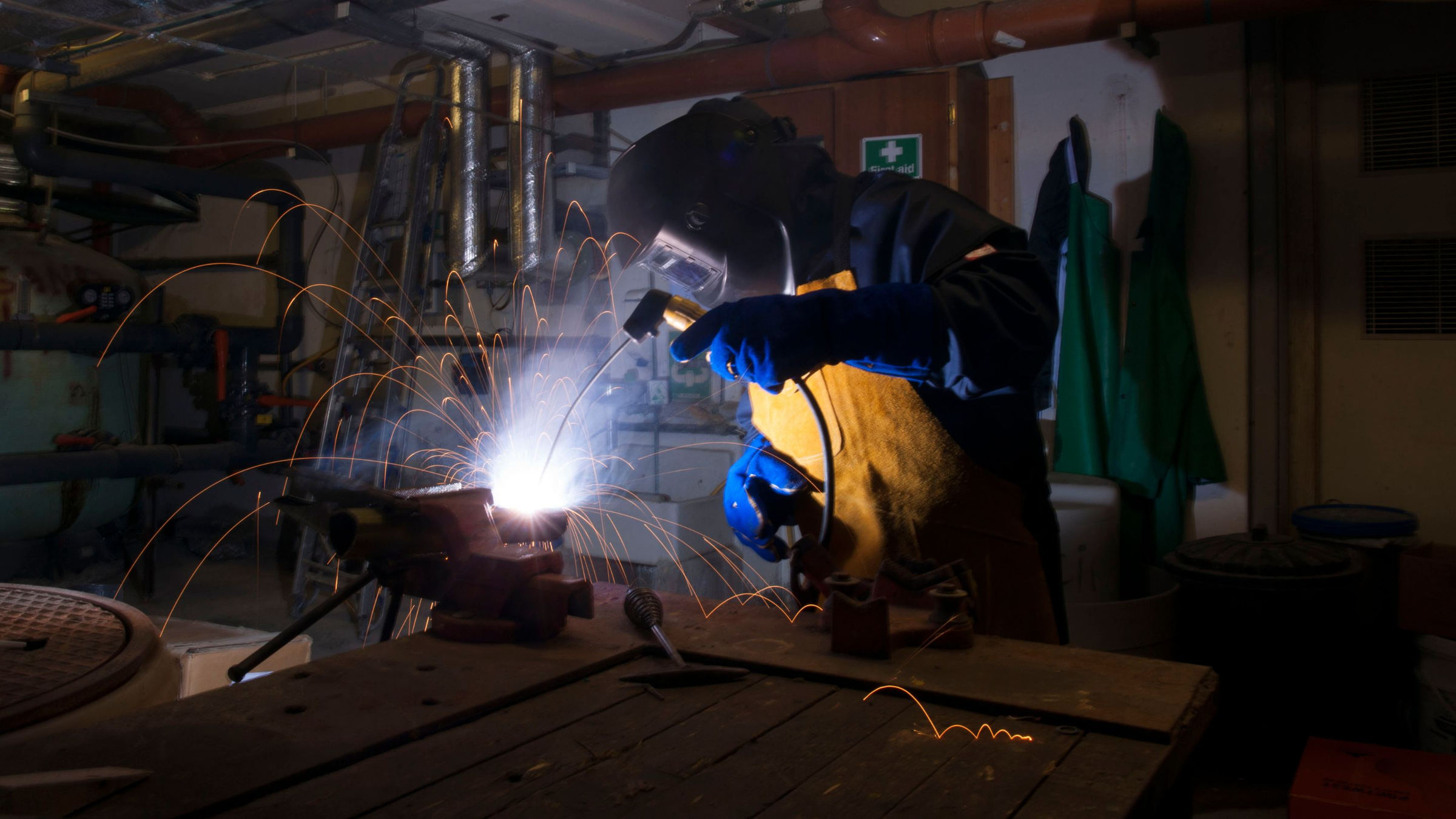 An image of a worker welding whilst wearing Portwest fire resistant workwear