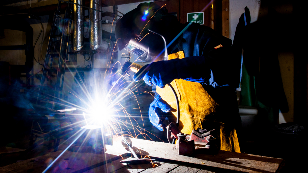 Worker wearing welder gloves