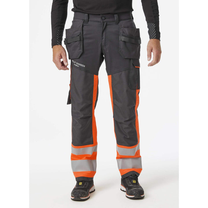 Helly Hansen Alna 2.0 Hi Vis Construction Stretch Trousers Class 1 Orange/Ebony 3 On Body 1#colour_orange-ebony