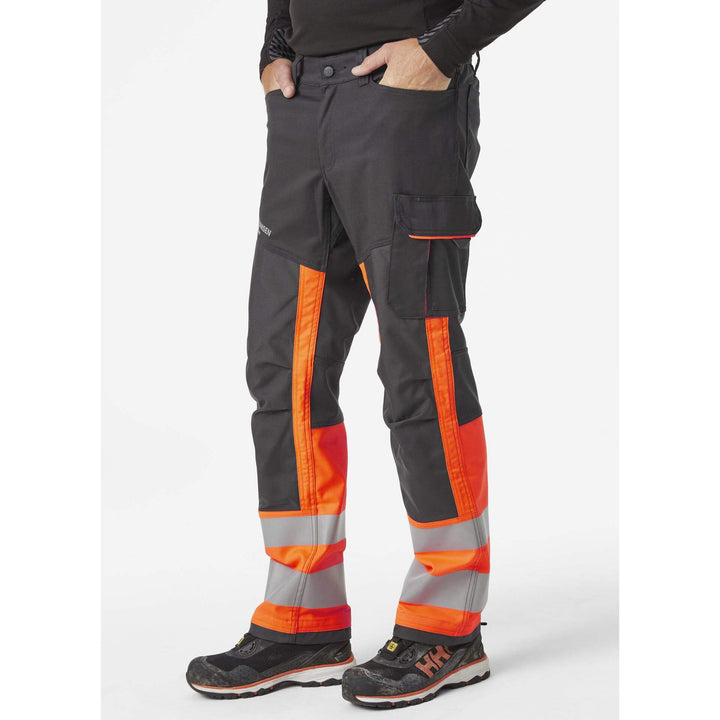 Helly Hansen Alna 2.0 Hi Vis Stretch Work Trousers Class 1 Orange/Ebony 3 On Body 1#colour_orange-ebony