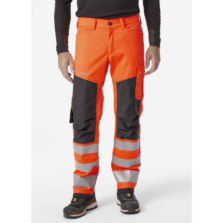 Helly Hansen Alna 2.0 Hi Vis Stretch Work Trousers Class 2 Orange/Ebony 3 On Body 1#colour_orange-ebony