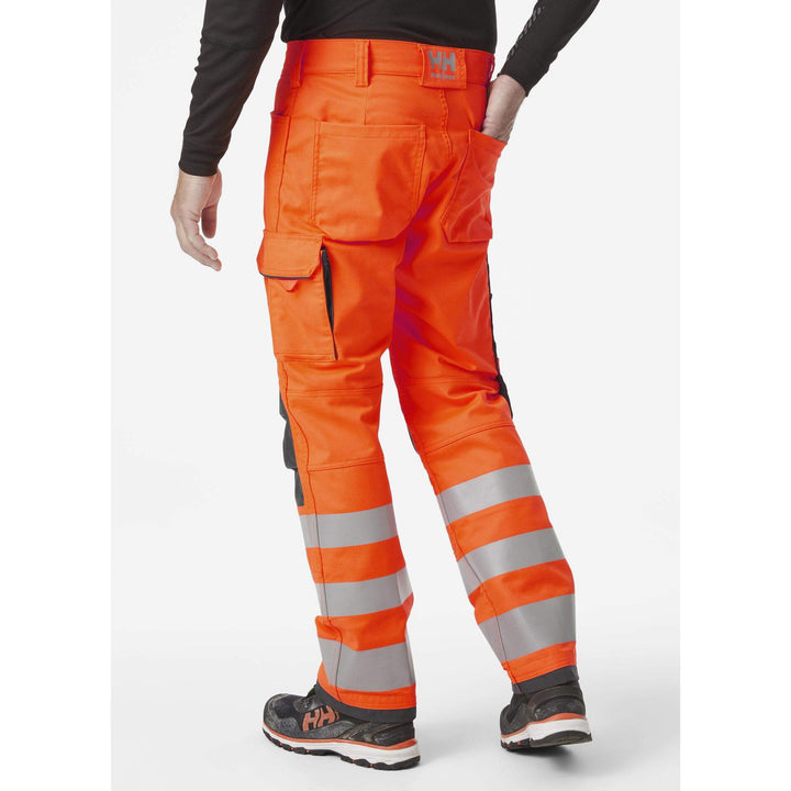 Helly Hansen Alna 2.0 Hi Vis Stretch Work Trousers Class 2 Orange/Ebony 4 On Body 2#colour_orange-ebony