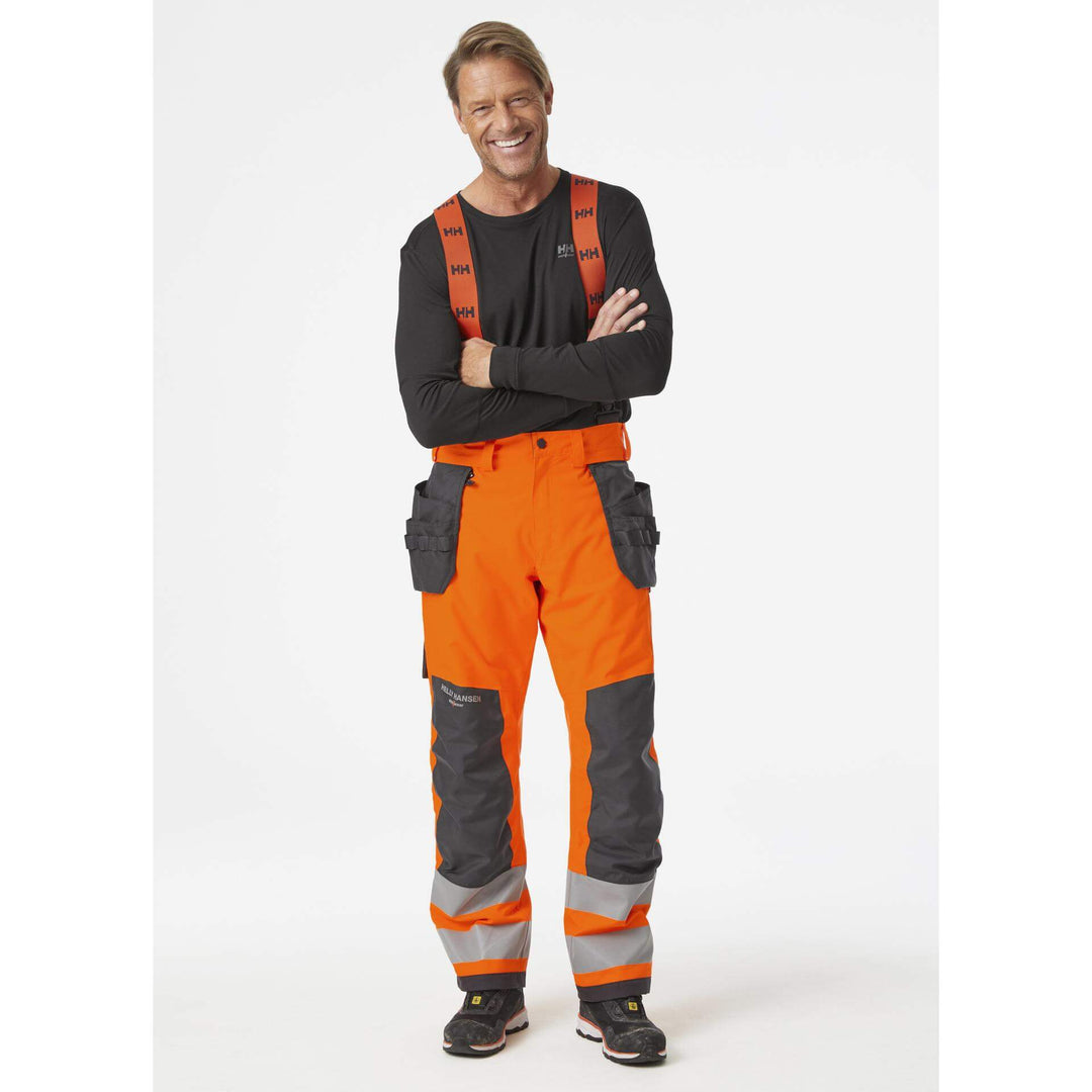 Helly Hansen Alna 2.0 Hi Vis Winter Insulated Construction Bib and Brace Trousers Class 2 Orange/Ebony 3 On Body 1#colour_orange-ebony