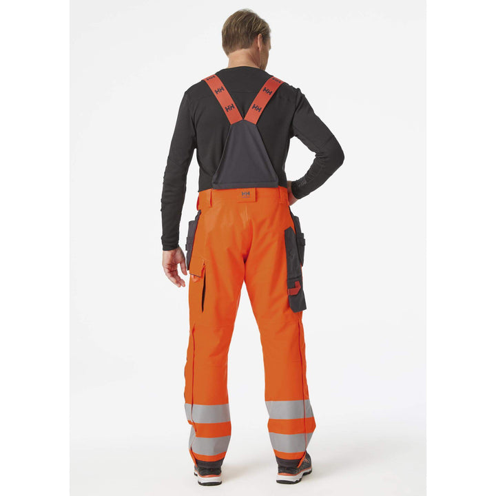 Helly Hansen Alna 2.0 Hi Vis Winter Insulated Construction Bib and Brace Trousers Class 2 Orange/Ebony 4 On Body 2#colour_orange-ebony