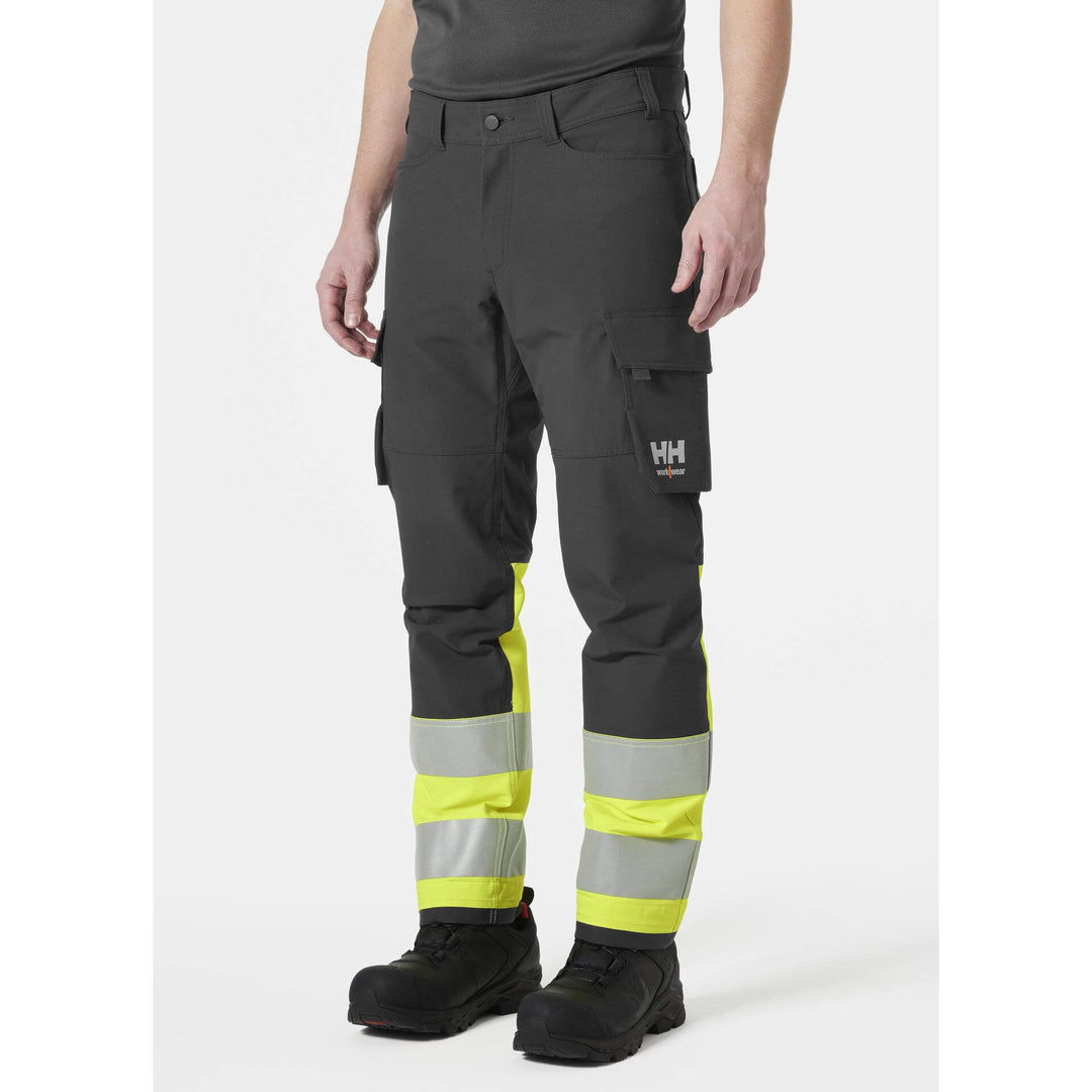 Helly Hansen Alna 4X Hi-Vis 4-Way-Stretch Cargo Trousers Class 1 Yellow/Ebony OnBody 1#colour_yellow-ebony