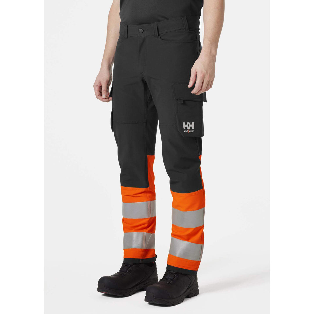 Helly Hansen Alna 4X Hi-Vis 4-Way-Stretch Cargo Trousers Class 1 Orange/Ebony OnBody 1#colour_orange-ebony