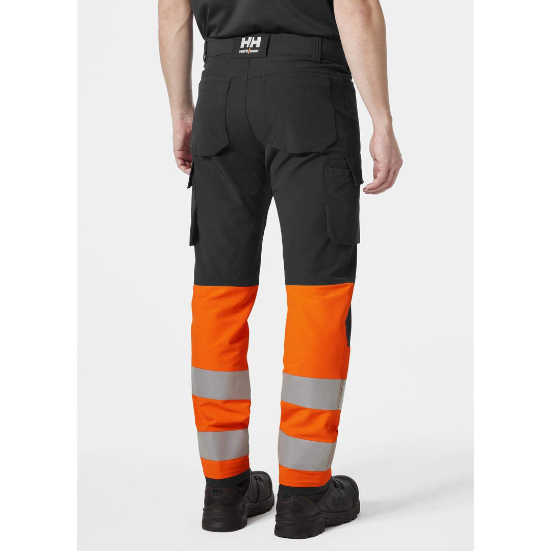 Helly Hansen Alna 4X Hi-Vis 4-Way-Stretch Cargo Trousers Class 1 Orange/Ebony OnBody 2#colour_orange-ebony