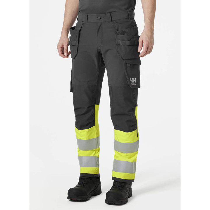 Helly Hansen Alna 4X Hi-Vis 4-Way-Stretch Construction Trousers Class 1 Yellow/Ebony OnBody 1#colour_yellow-ebony