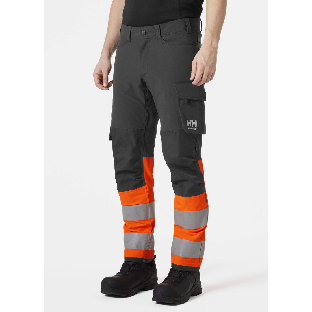 Helly Hansen Alna 4X Hi-Vis 4-Way-Stretch Work Trousers Class 1 Orange/Ebony OnBody 1#colour_orange-ebony