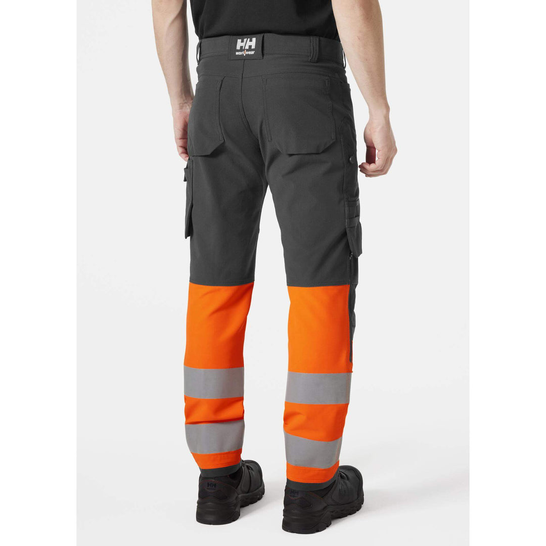 Helly Hansen Alna 4X Hi-Vis 4-Way-Stretch Work Trousers Class 1 Orange/Ebony OnBody 2#colour_orange-ebony