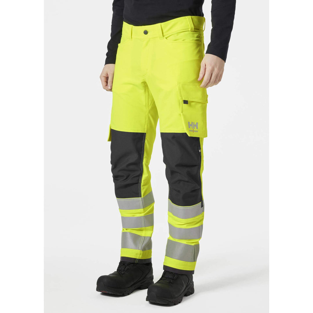 Helly Hansen Alna 4X Hi-Vis 4-Way-Stretch Work Trousers Class 2 Yellow/Ebony OnBody 1#colour_yellow-ebony