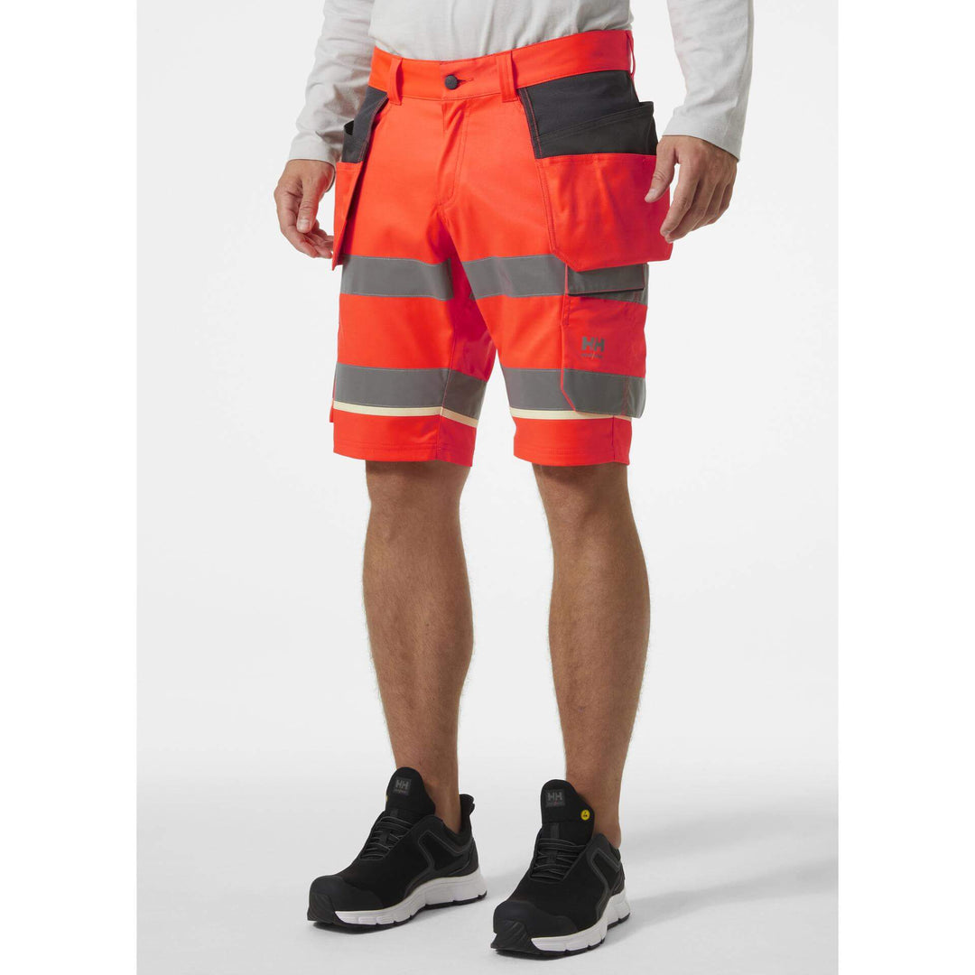 Helly Hansen UC-ME Hi-Vis Stretch Construction Shorts Red/Ebony OnBody 1#colour_red-ebony